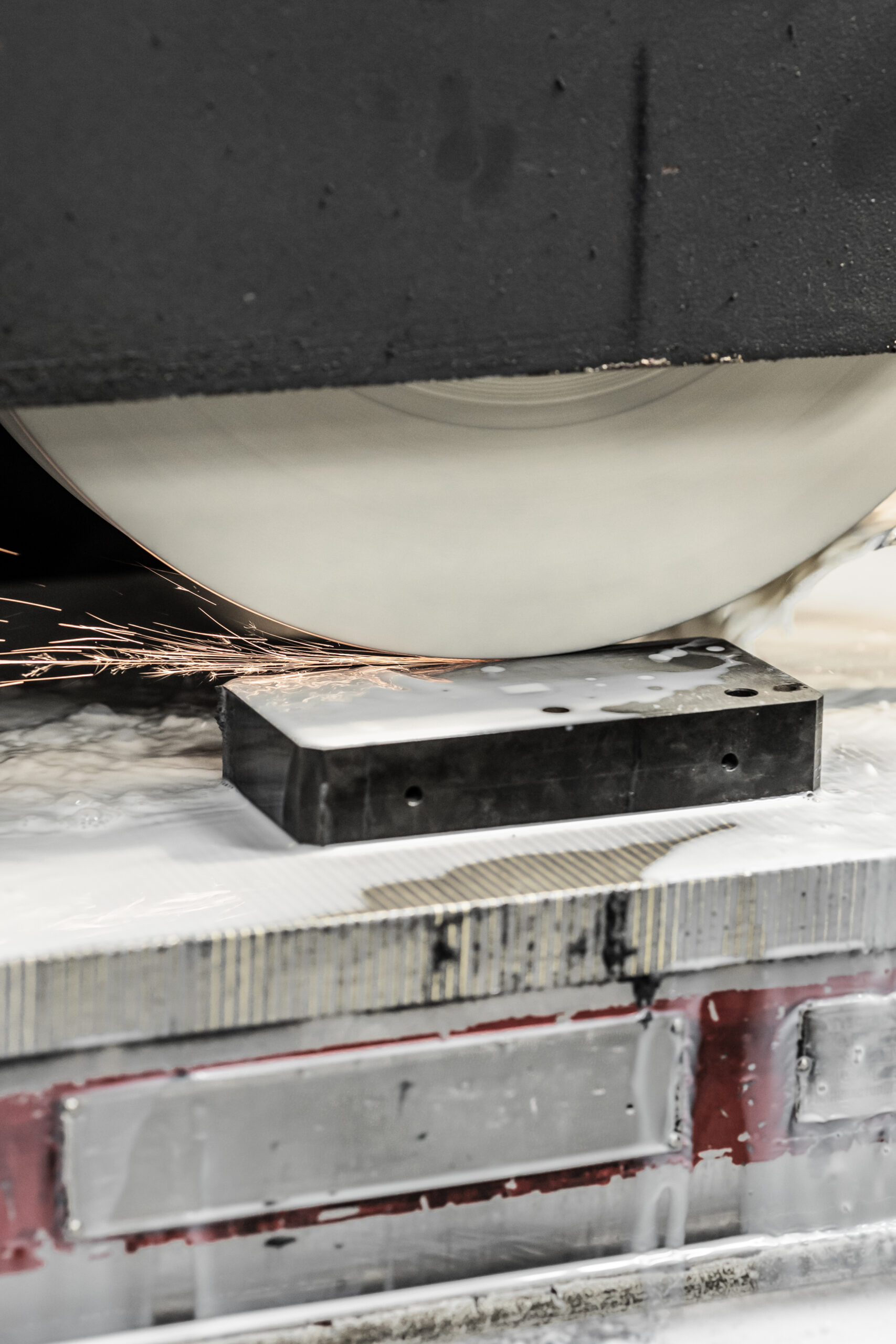 industrial metal grinding machine cutting with coolant and sparks