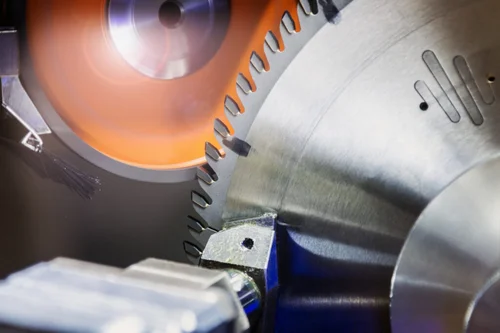 Close-up product image of a circular saw blade in action, showing sharp teeth cutting through material with sparks and motion blur, emphasizing precision, industrial use, and manufacturing efficiency.